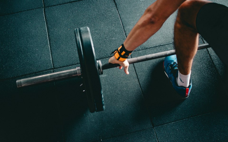 Athlete gripping a barbell before a lift