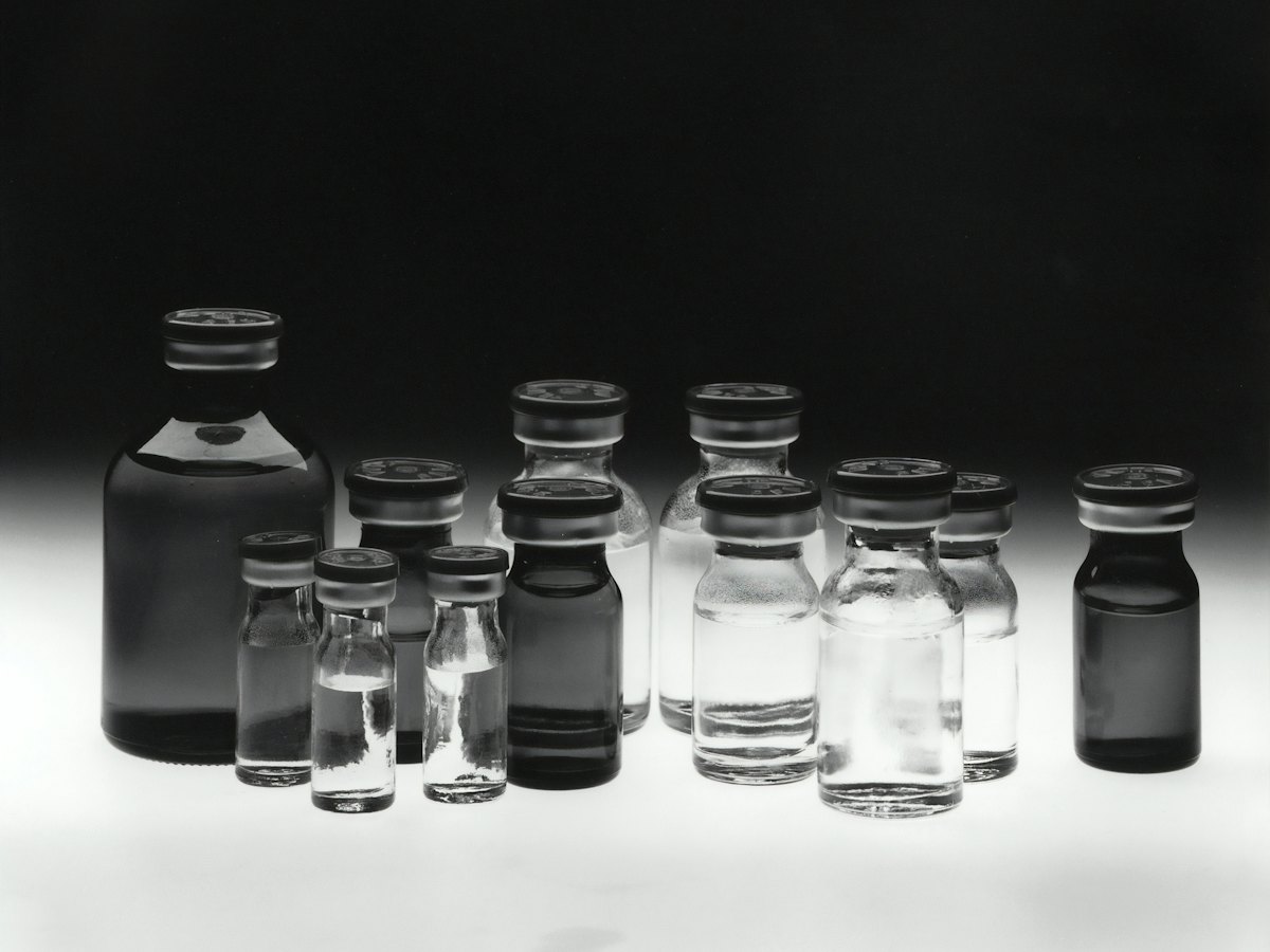Rows of glass vials, backlit